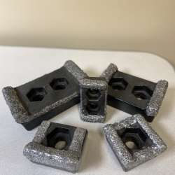Five grinder tips arranged on a table with two larger ones and three smaller ones.
