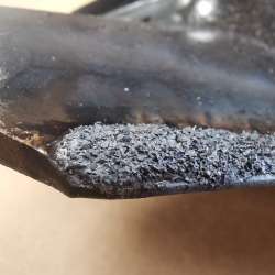 The edge of a Caden Edge sweep with the specially formulated carbide wear surface